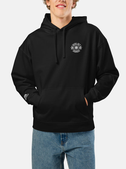 Model wearing Chase the Sun Oversized Embroidered Hoodie front in black — Seas Get Degrees men's coastal hoodie