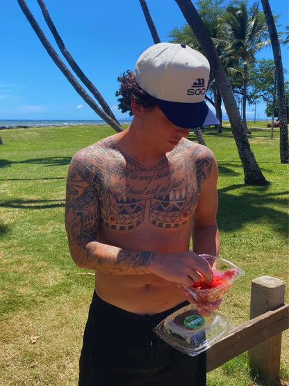 Classic SGD Snapback in navy and natural with strawberries on the beach — Seas Get Degrees coastal lifestyle