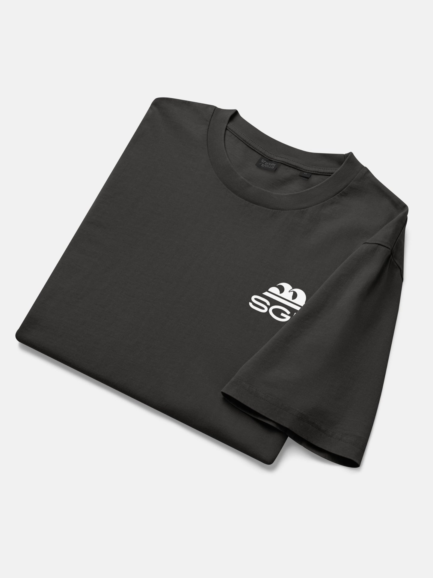 Endless Wave Tee folded flat lay in black rock — Seas Get Degrees