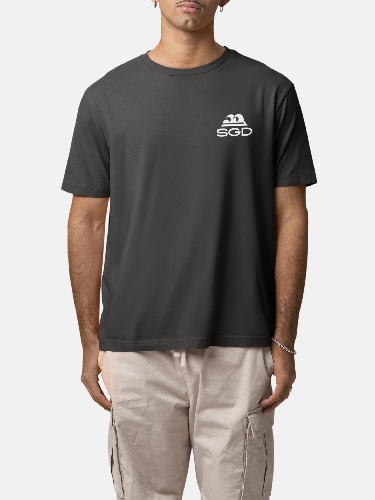 Model wearing Endless Wave Tee front in black rock — Seas Get Degrees men's coastal tee