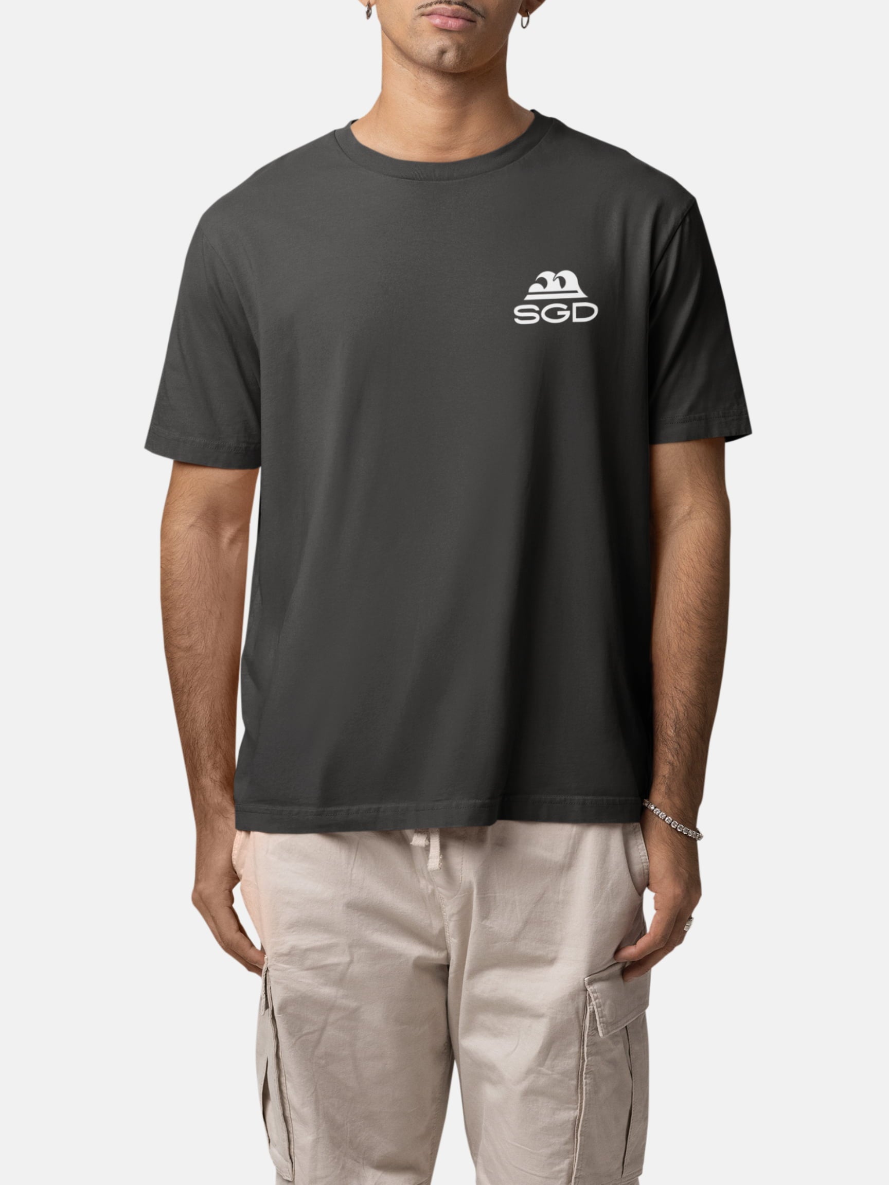 Model wearing Endless Wave Tee front in black rock — Seas Get Degrees men's coastal tee