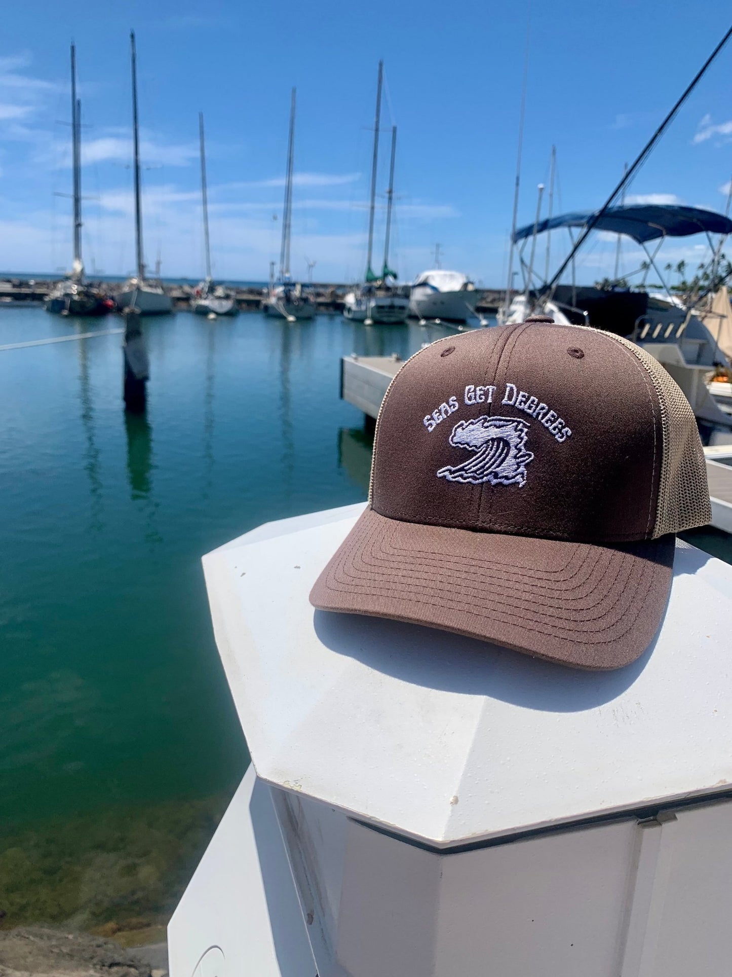 Endless Wave Trucker Hat worn at boat harbor in brown and khaki — Seas Get Degrees lifestyle