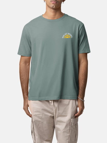 Model wearing Golden Tide Tee front in green bay — Seas Get Degrees men's coastal tee