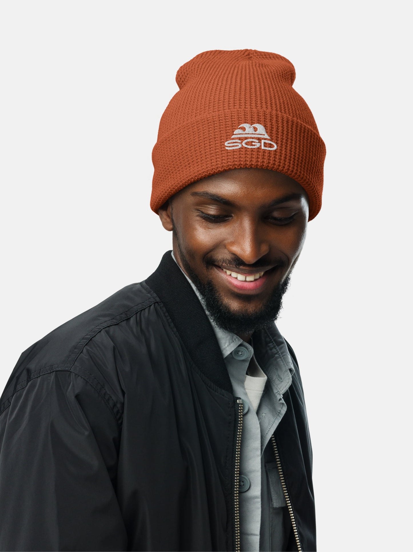 Model wearing SGD Waffle Beanie in rust — Seas Get Degrees coastal beanie